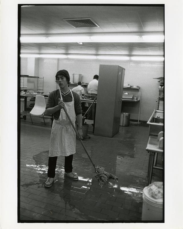 Student mopping the floor