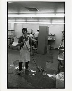 Student mopping the floor