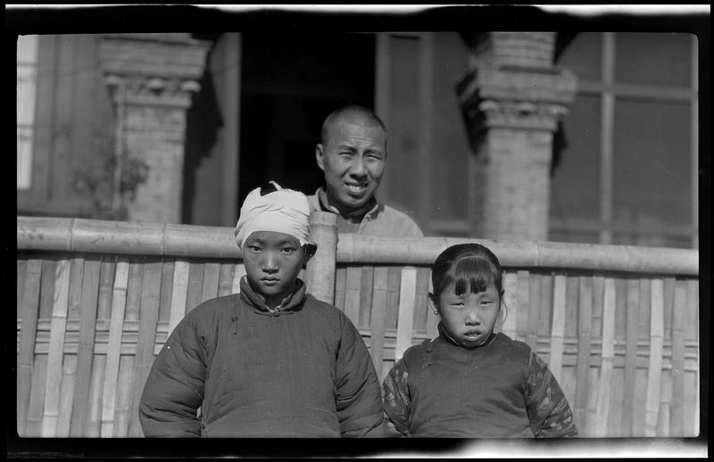 Three people at Yangtse-Poo medical and social community center