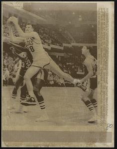 Boston-Celtics-Lakers-Celtics' Bailey Howell (fore) grimaces as he takes to the air between Lakers' Jim Barnes (behind Howell) and Gail Goodrich(R), for two-pointer layup, 2nd period, Boston Garden (1 1/2). Celtics won game, 133-108.