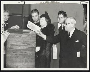 Nichols Votes - Ex-Mayor Malcolm E. Nichols casts his ballot at Curtis Hall, Jamaica Plain. Left to right are Clark Nichols, Mrs. Nichols, Dexter Nichols and the candidate for mayor.