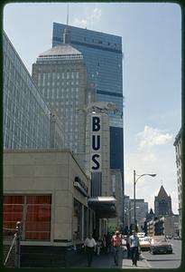 Looking up a street toward old and new John Hancock buildings, Greyhound bus terminal in foreground