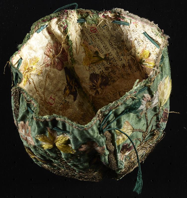 17th-century embroidered silk purse stabilized with fragments of medieval manuscript waste