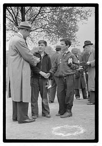 Two boys, both wearing medals, shaking hands