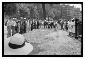 Two young women playing horseshoes