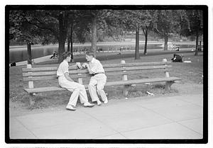 Two men sitting on a bench by Frog Pond, Boston Common