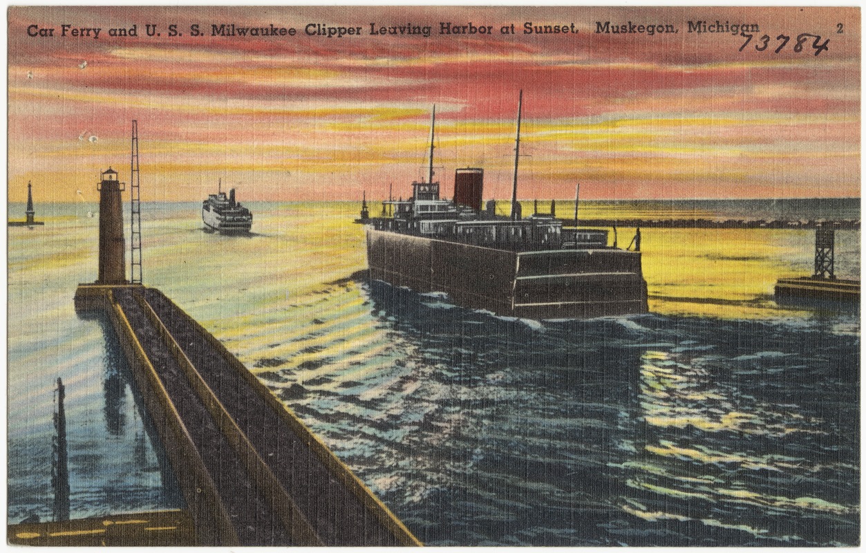 Car ferry and U. S. S. Milwaukee clipper leaving harbor at sunset, Muskegon, Michigan