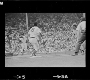 Red Sox first baseman Carl Yastrzemski (#8) gets ready to catch an attempted pick-off throw from Boston Red Sox pitcher Bill Lee as New York Yankees base runner Thurman Munson steps back towards first base with unknown umpire looking on