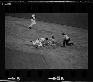 Boston Red Sox 2nd baseman Doug Griffin (#2) attempts to tag sliding Baltimore Orioles base runner Rich Coggins (#2) as unknown umpire look on