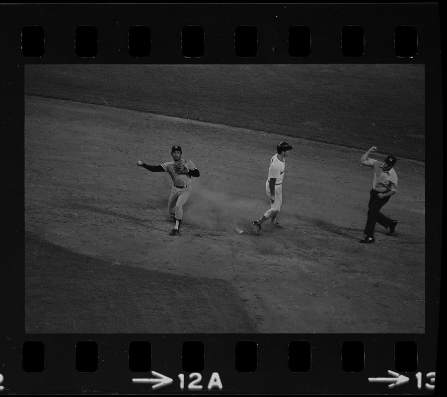 Unknown umpire signals Boston Red Sox base runner Rick Burleson (#7) out at 2nd base as New York Yankees 2nd baseman Sandy Alomar, Sr. (#2) attempts to complete the throw to first base