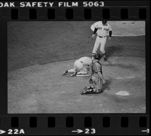 Red Sox batter Rick Burleson (#7) kneels on ground after being hit with a pitch by Texas Rangers pitcher Doc Medich in the bottom of the 7th inning as Red Sox coach Walt Hriniak approaches and Texas Rangers catcher Jim Sundberg (#10) looks on at home plate