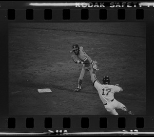 Texas Rangers shortstop Nelson Norman (#4) attempts to complete a double play as advancing Red Sox base runner Tom Poquette (#17) hits the deck