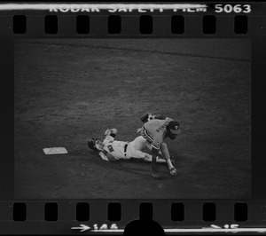 Texas Rangers shortstop Nelson Norman (#4) attempts to complete a double play and avoid advancing Red Sox base runner Tom Poquette (#17)