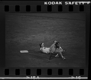 Texas Rangers shortstop Nelson Norman (#4) attempts to complete a double play and avoid advancing Red Sox base runner Tom Poquette (#17)