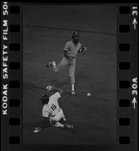 Texas Rangers shortstop Nelson Norman (#4) attempts to complete a double play as Boston Red Sox base runner Bob Watson (#5) slides towards second base