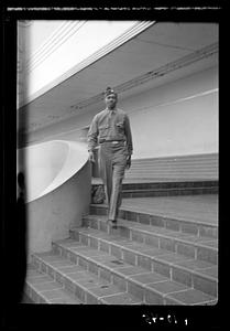 A man in military uniform walking down stairs