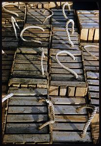Rows of wooden crates with rope handles