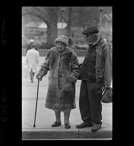 Elderly brother and sister wait to cross Park Street, Boston