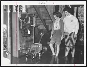Oil Burner Damage that is typical in hundreds of homes in the Stoneham-Melrose-Wakefield area, and has deprived residents of heat, is examined by Barbara and Marcia Steeves in their home at 16 Wilson road, Stoneham.