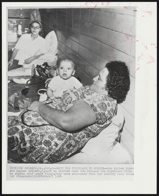 Wait for Hurricane To Strike--Mrs Walter Buras and nephew Anthony, 2, wait in shelter near New Orleans for hurricane Hilda to strike gulf coast today. They were evacuated from low country near coast.