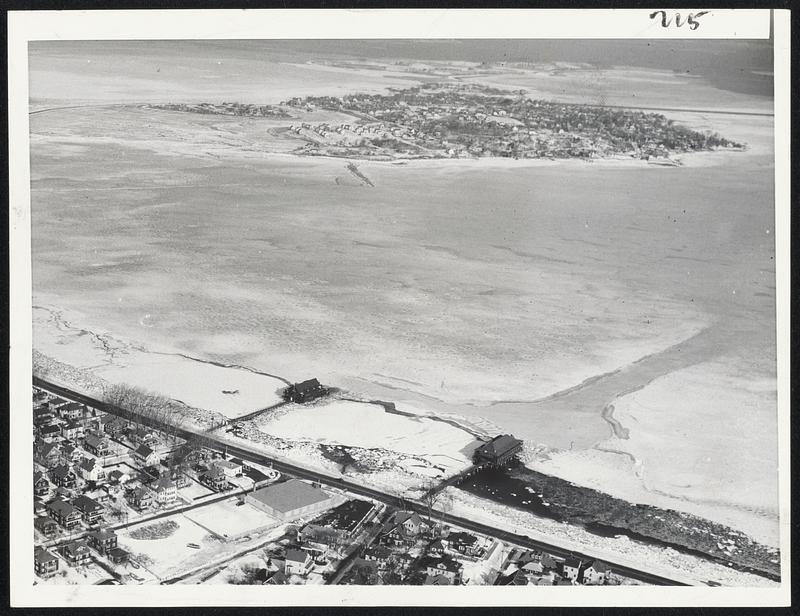 The Frozen North? No, Quincy bay, as it appeared today to a cameraman from the air. The bay is frozen solid. Squantum and Wollaston Yacht Clubs, which have been threatened by heavy ice, are in foreground. Squantum is in the distance.