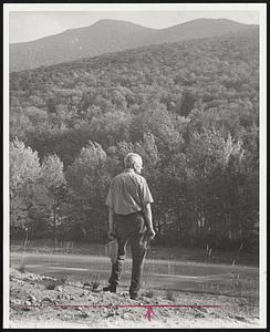 Adams in Eden-Sherman Adams, 65, former chief of staff for President Eisenhower, scans woods near Loon Mt., near Lincoln, N.H., where he is constructing a $700,000 ski area.