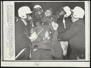 Surrounded by Police--Police restrain a man during an outbreak of violence in Washington tonight. A barrage of rocks and bottles from one segment of the demonstrators attending the Vietnam Moratorium rally was answered with tear gas.
