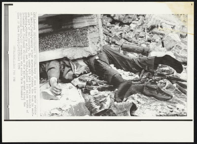 Earthquake Victim -- Body of man lies under rubble at Gediz, Turkey, Sunday after earthquake struck the town in western part of the country. The quake hit just before midnight Saturday, virtually wiping out Gediz, located 150 miles south of Istanbul, and flattened villages for miles around along the Anatolian fault.