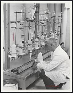 Still Going on are the regular surveys of radioactive Strontium 90 concentrations in milk. Public Health Service technician Harry Lumsden is shown timing the laboratory's test procedures.