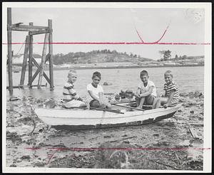 High and Dry on Mud Flats near Price's Yacht Club, Marblehead, are these youngsters waiting for the tide to come on. Left to right, Peter Connors, 7; John Willard, 8; William Haskell, 10, and William Powers, 7.