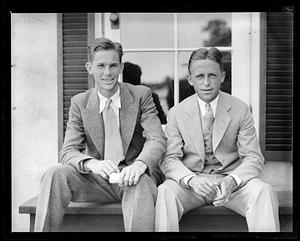 Two smiling unidentified men, seated