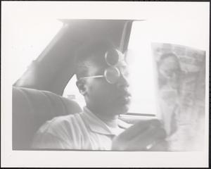 Young man reading in the car