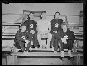 Five men on benches in McCurdy Natatorium