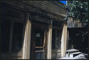 Entrance to wooden building with sign on door "Gone to dinner," Nevada City, Montana
