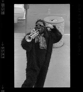 Person in ape costume with trumpet