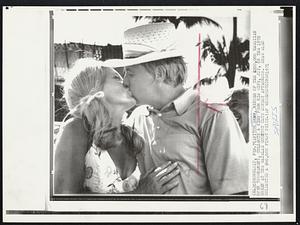 Tom Shaw, winner of the $200,000 Hawaiin open tournament, collects a kiss from his wife, Joy, on the 18th green at the Waialae Country Club Sunday afternoon. Shaw also collected a $40,000 first prize.