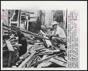 Dejected Victims--A man and his dog view wreckage of their tornado demolished home in Galveston, Wednesday. The city suffered a beating by high tides, floodwaters, winds, and a tornado, all a part of hurricane Carla's fury.