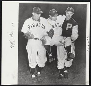 Injured Pirate - Coach Bill Posedel (left) and Infielder Jack Phillips carry their teammate, Outfielder Wally Westlake, from the field after he was spiked trying to get back to second base in last night's game with Cincinnati at Forbes Field, Pittsburgh.