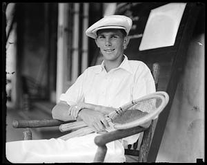 A tennis player, seated