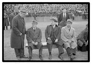 Boston Park Department Commissioner William Long looking down at three seated men