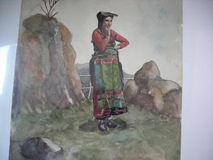 Woman in costume with left hand raises to her face