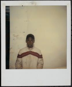 Boy posing in front of a wall