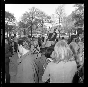 Protesters with signs, one reading "Tricky Dick Eats Grapes!"