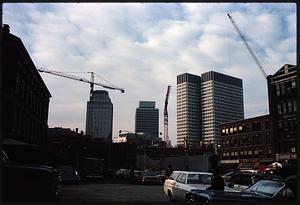 View from parking lot of cranes and tall buildings, Boston