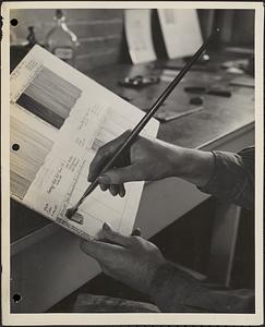Photograph showing technician painting out panel for a special fading rate test