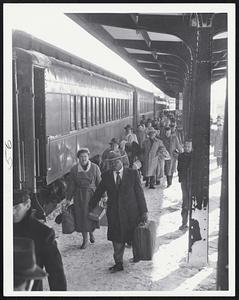 Back At Last -- Weary travelers, the men with beards, trudge off train after 29-hour trip from Washington to Boston. Trouble with Diesels caused most of the delay. The run from the capital usually takes nine hours.