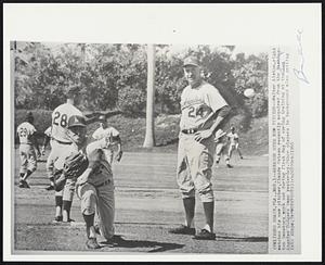 Manager Eyes New Pitcher--Walter Alston, right watches his new pitcher, Claude Osteen recently acquired from the Washington Senators work out during first day of spring training at the Los Angeles Dodgers camp yesterday. Other players in background also getting into shape.
