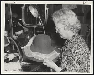Evolution of a Hat. The story of how a hat may be made in five easy (if you've got the hang of it) steps is told in the accompanying photographs by Herald Staff Photographer Maynard White. Hat maker is Miss Cora Bernard, and model is Miss Susie Bell. Starting to Make the Hat, Miss Bernard places pattern on form. Hat will look like model at immediate left of pattern's brim when completed.