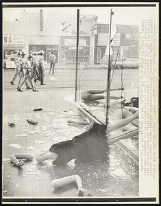 Deputy Sheriffs sweep the area after violence erupted following a National Chicano Moratorium Antiwar Rally. Deputies ordered all persons off the streets in a five-square block area. Two dozen persons were injured, two of them seriously. Almost all the windows in the shopping area were broken. Several buildings were set on fire. One of them burned to the ground.