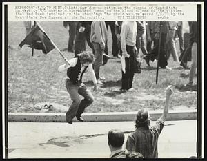 Anti-war demonstrator on the campus of Kent State University,5/4 during disturbances jumps on the blood of one of the victims that had been involved in the shootings. The photo was released 5/5/70 by the Kent State New Bureau at the University.